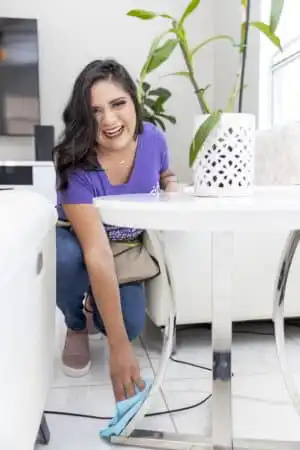 Residential Cleaner dusting furniture