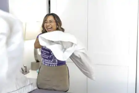 Residential Cleaner making a bed