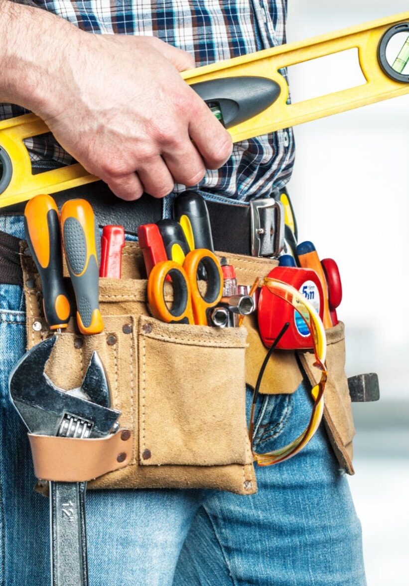 Handyman holding ruler