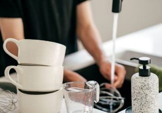 house_cleaning_tips_02 Professional cleaner from CleanFlorida tidying a modern coastal home in Naples FL